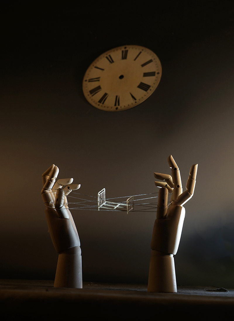 surrealism, dream, cat’s cradle, hands, carved hands, wooden hand, clock, bed, float, string, articulated hand, surreal hands